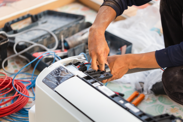 HVAC technician servicing outdoor air conditioning equipment
